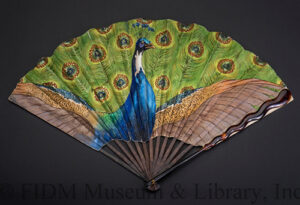 Photo of a vibrant green and blue fan depicting a peacock, from the Mona Lee Nesseth collection. Photo courtesy of ASU-FIDM Museum.